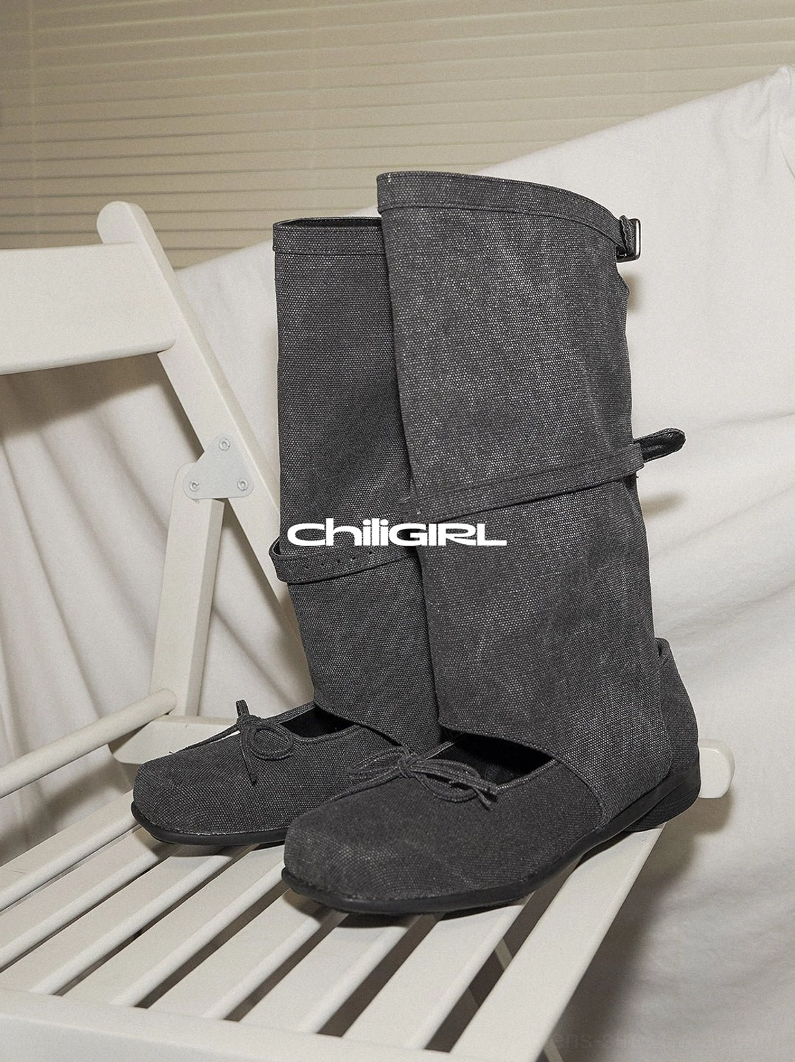 Front display of black washed denim Mary Jane boots with mid-calf shaft, double buckles and bow toe