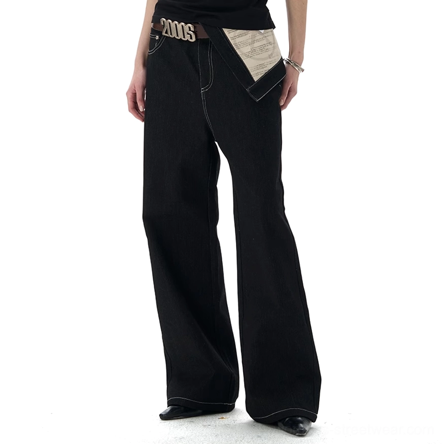 Three-quarter studio view of black washed denim jeans with relaxed wide straight-leg cut and visible cotton texture