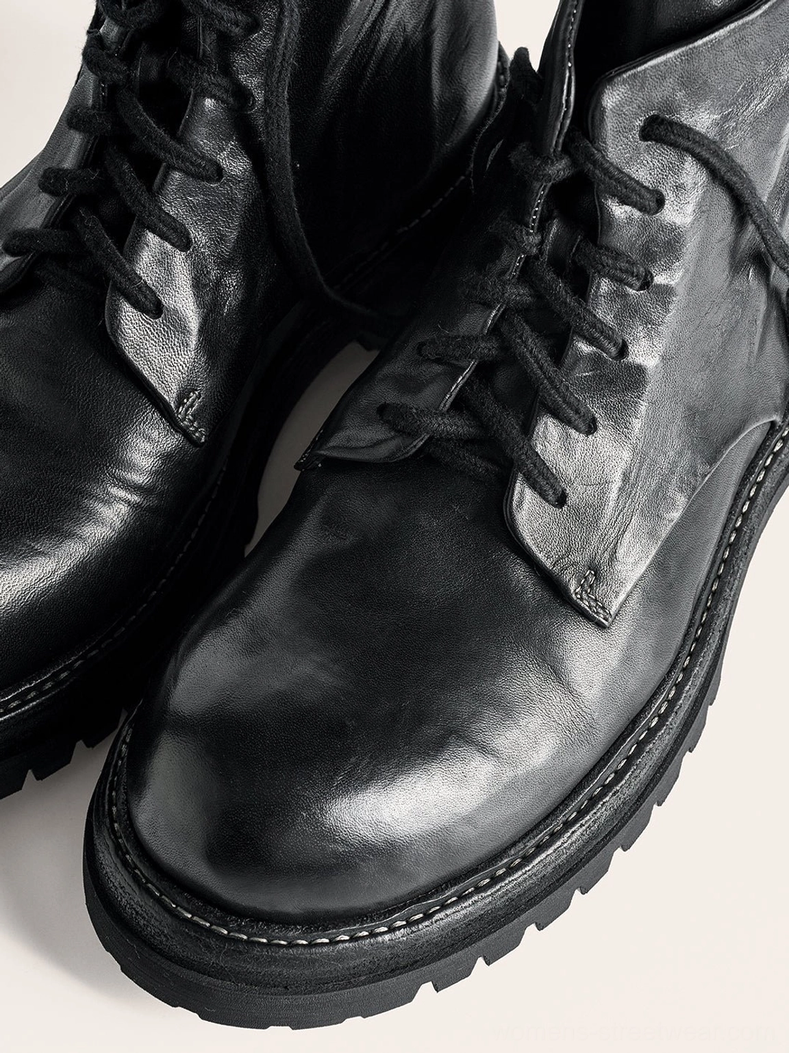 Black washed horsehide rear-zip combat boots product image featuring vintage leather texture, front lacing, rounded toes, and lugged soles
