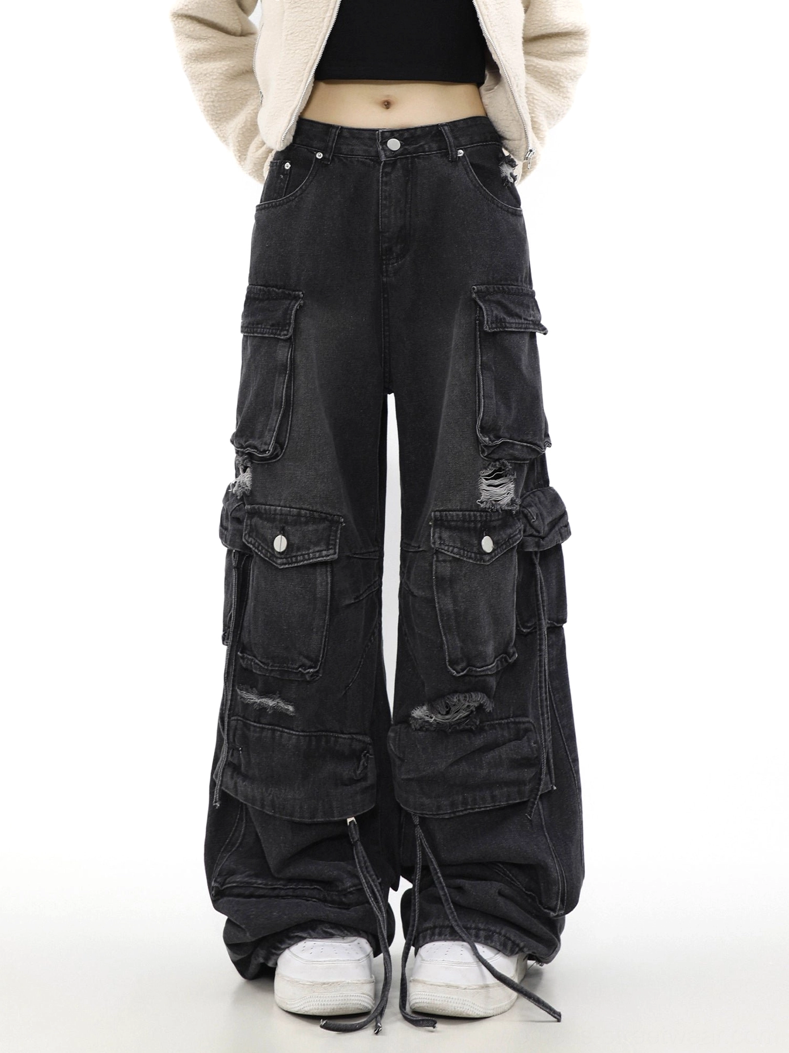 Straight front model view of black washed wide-leg cargo jeans with symmetrical snap-flap pockets and distressed knee details