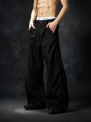 Black wave contour wide-leg streetwear trousers shown in a waist-focused front view with a clean waistband and structured extra-wide legs