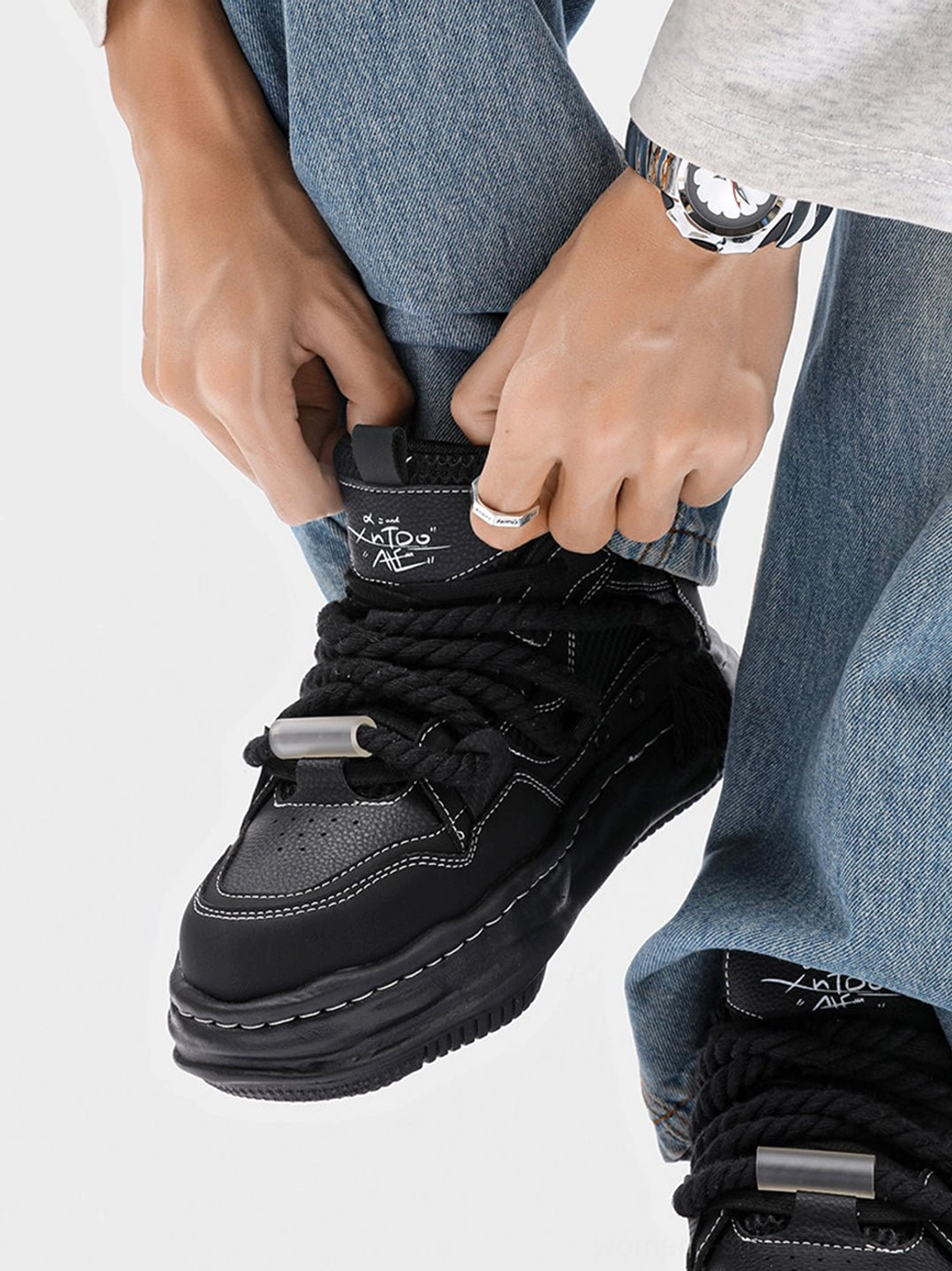 Black wavy platform sneakers featuring thick rope laces metal toggle and sculptural 7CM sole