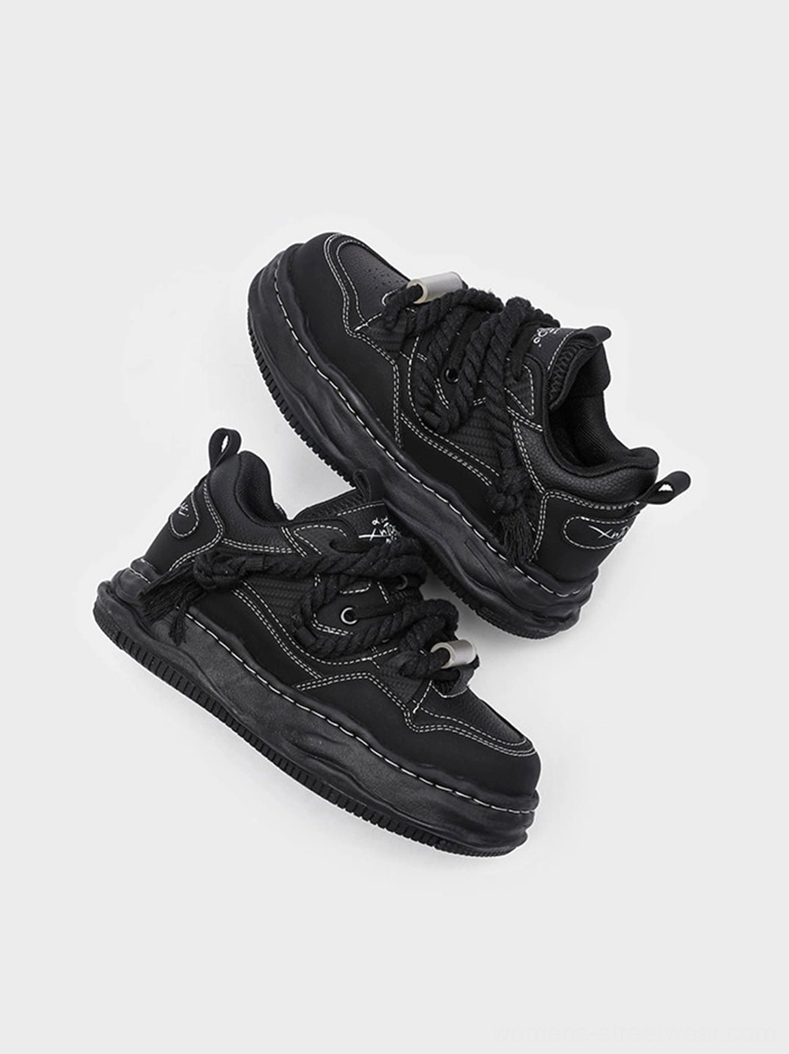 Black wavy sole platform sneakers with contemporary avant-garde proportions and versatile casual styling