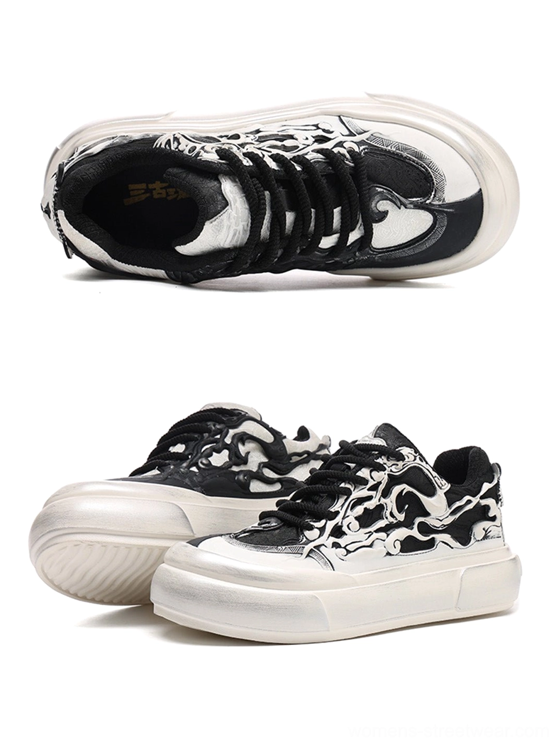 Black and white alternative streetwear platform sneakers featuring flame artwork skull graphics black laces and oversized chunky proportions