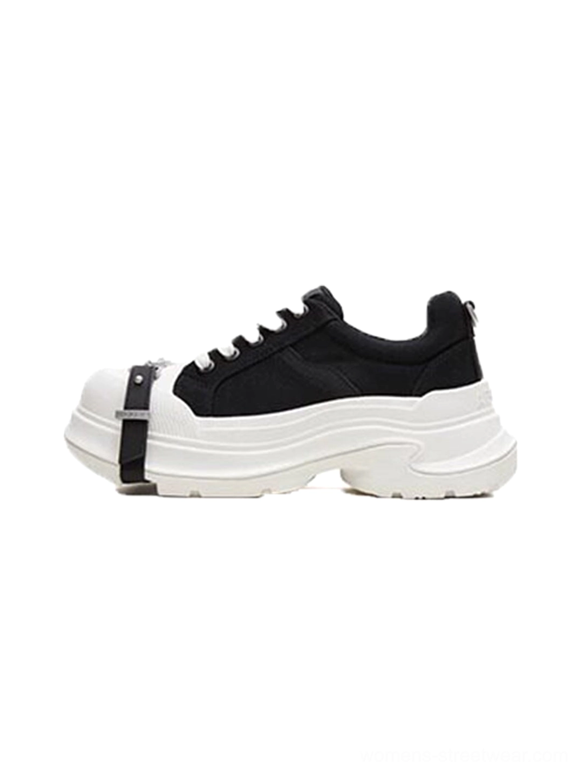 Side profile of black and white buckle platform canvas sneakers with silver toe strap, contrast toe cap, lace-up front, and chunky wave sole