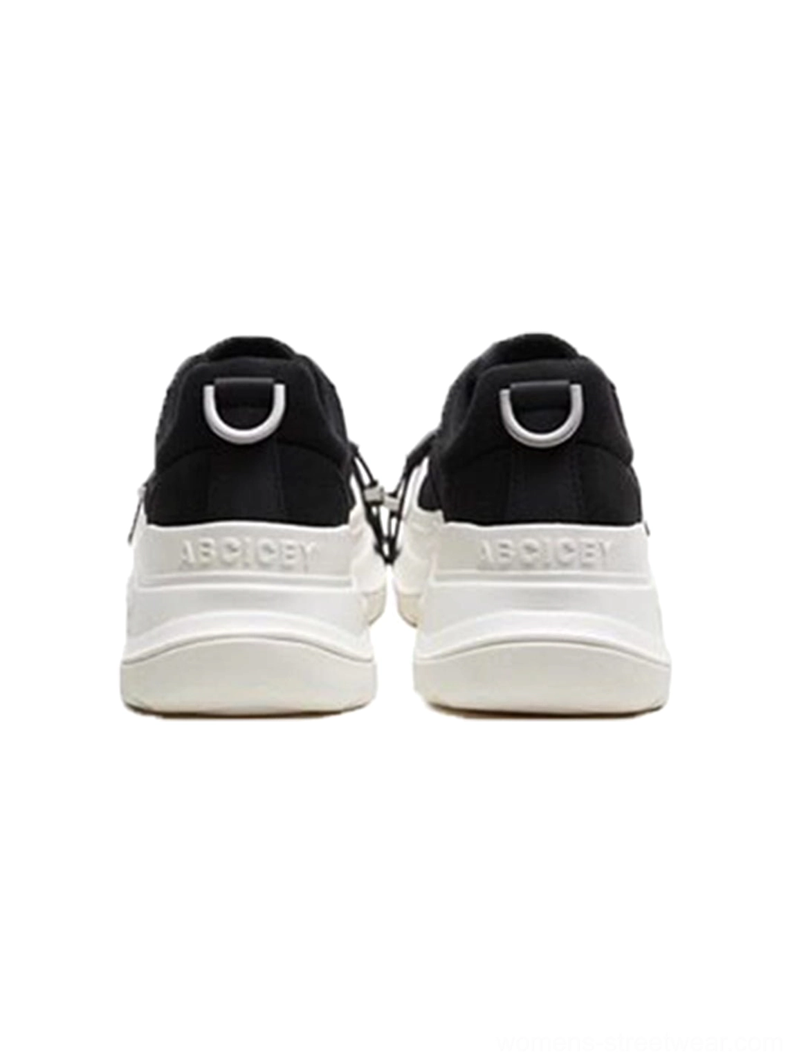 Rear view of black and white buckle platform canvas sneakers with silver D-ring heel pull tabs, black heel panels, and chunky white soles