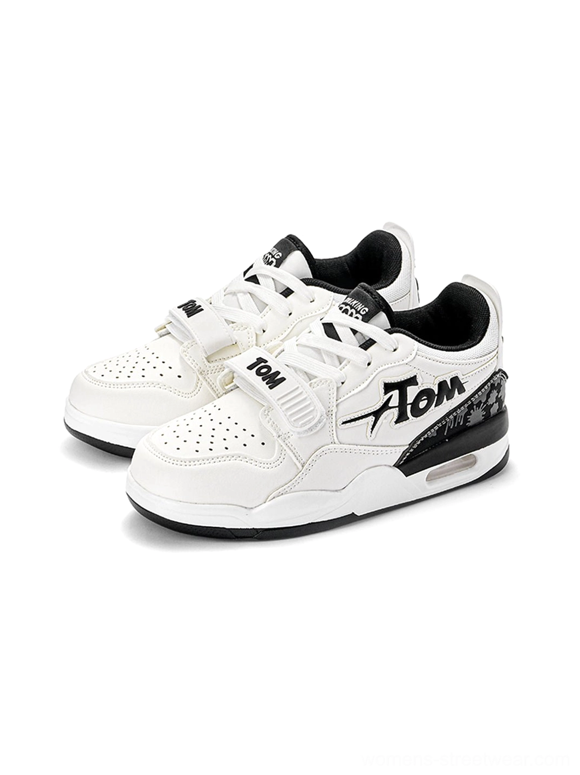 Black and white colorblock basketball-inspired court sneakers with bold layered panels, lace-up front, adjustable strap, and chunky cushioned sole