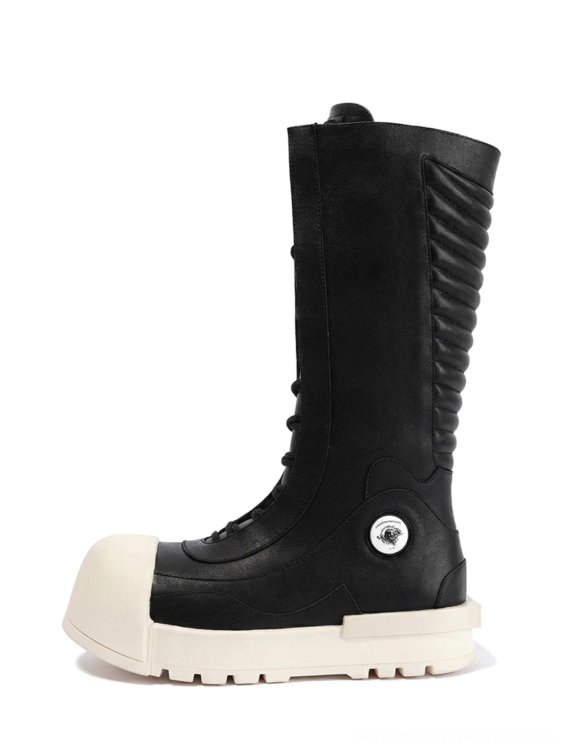 Side profile of black and white contrast toe mid-calf platform boots with ruched shafts, off-white sculpted soles, and silver ankle badges