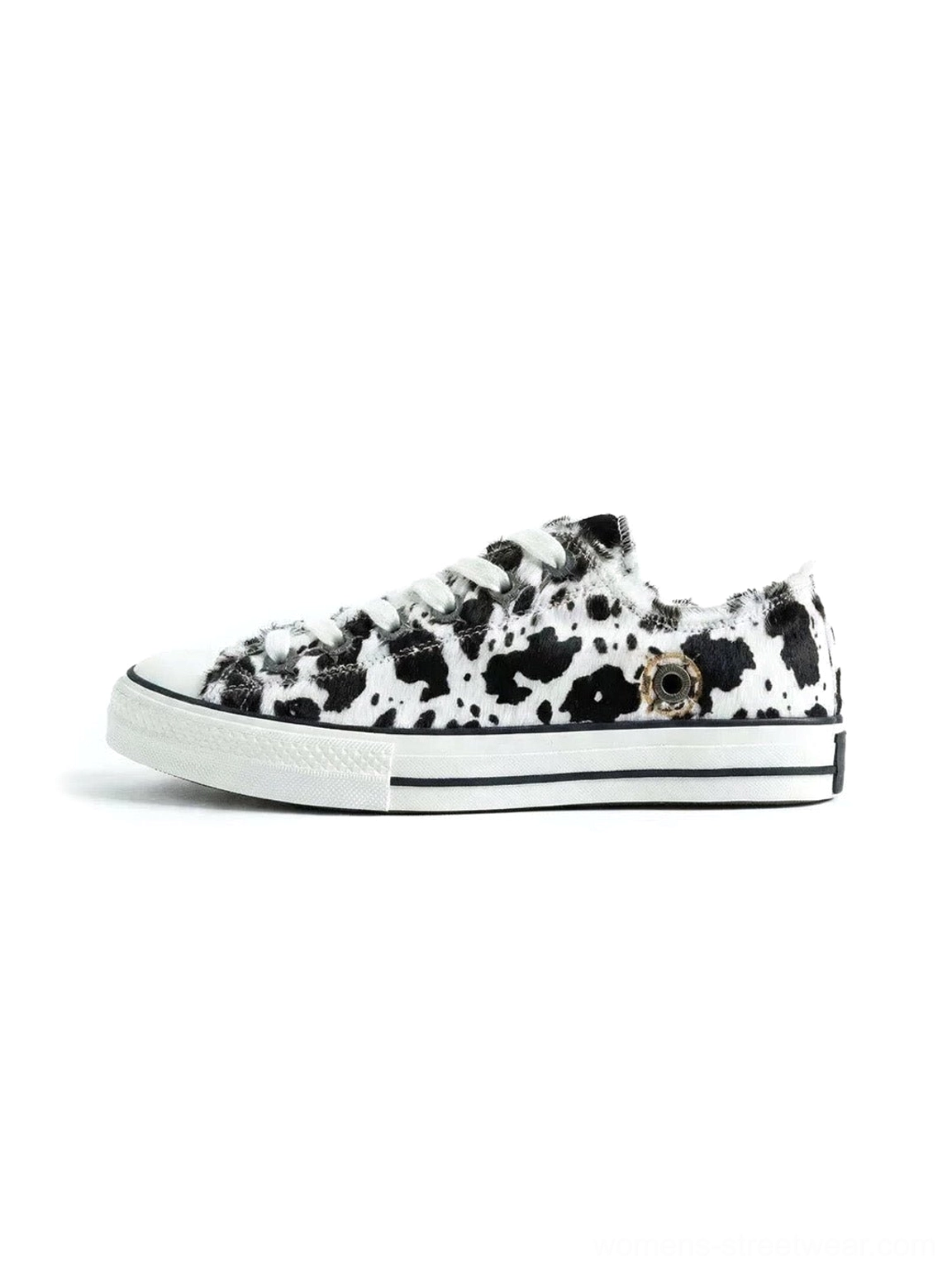 Black and white cow print cowhide low-top sneakers with classic lace-up construction, rounded toe, and flat retro vulcanized outsole
