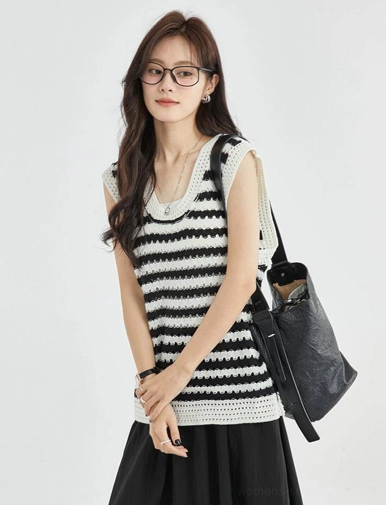 Black and white crochet knit striped vest top shown from the front side with contrasting white neckline and hem trim and a loose streetwear silhouette