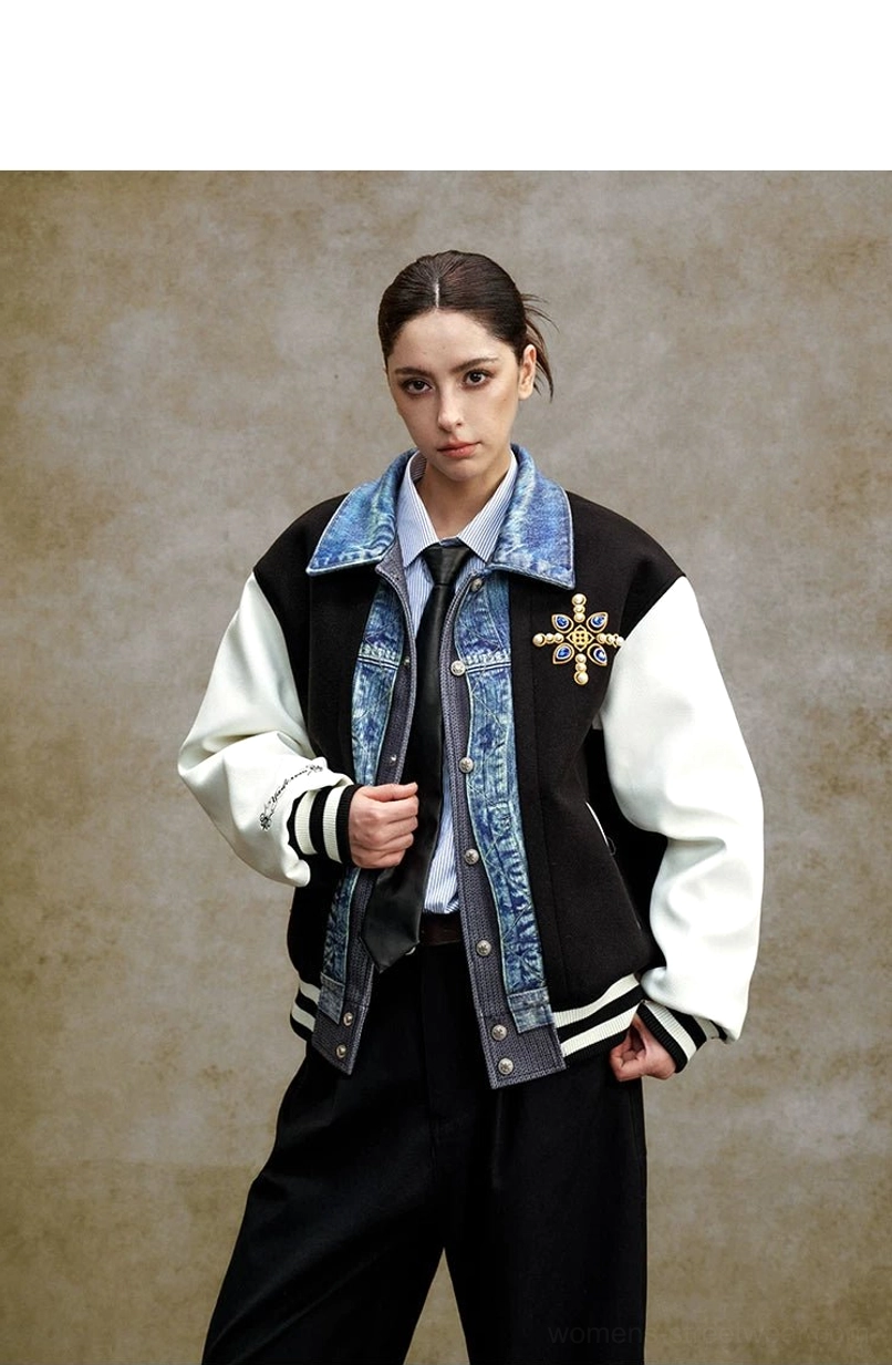 Black and white embroidered varsity bomber jacket with denim-effect placket, striped ribbed hem, contrasting sleeves, and preppy tie styling