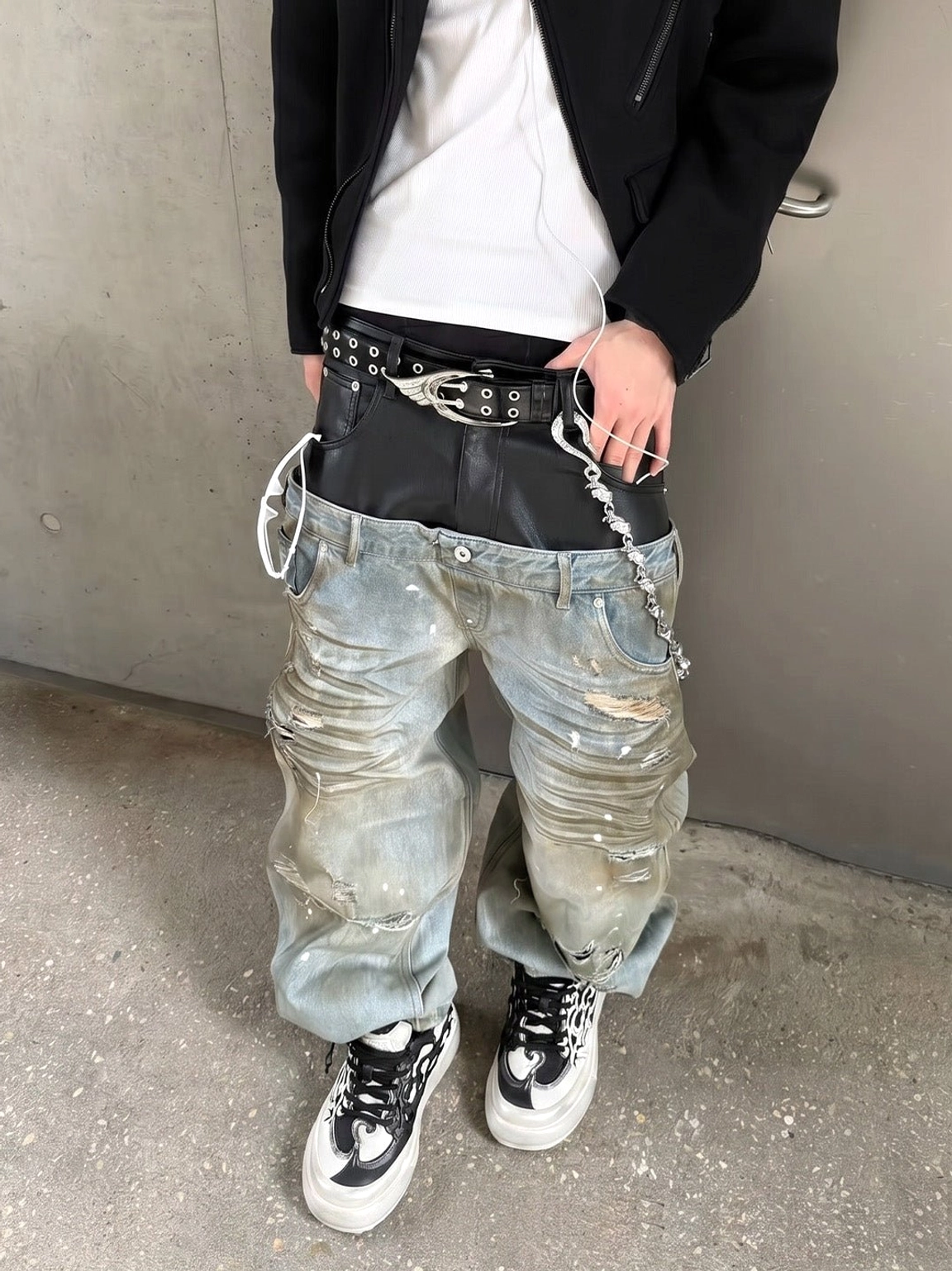 Black and white flame platform sneakers worn with a black blazer white T-shirt and vintage washed jeans for elevated streetwear styling