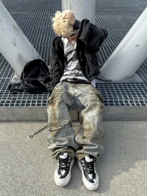 Model wearing black and white flame platform sneakers with wide leg jeans in a Y2K streetwear outfit on an industrial metal platform