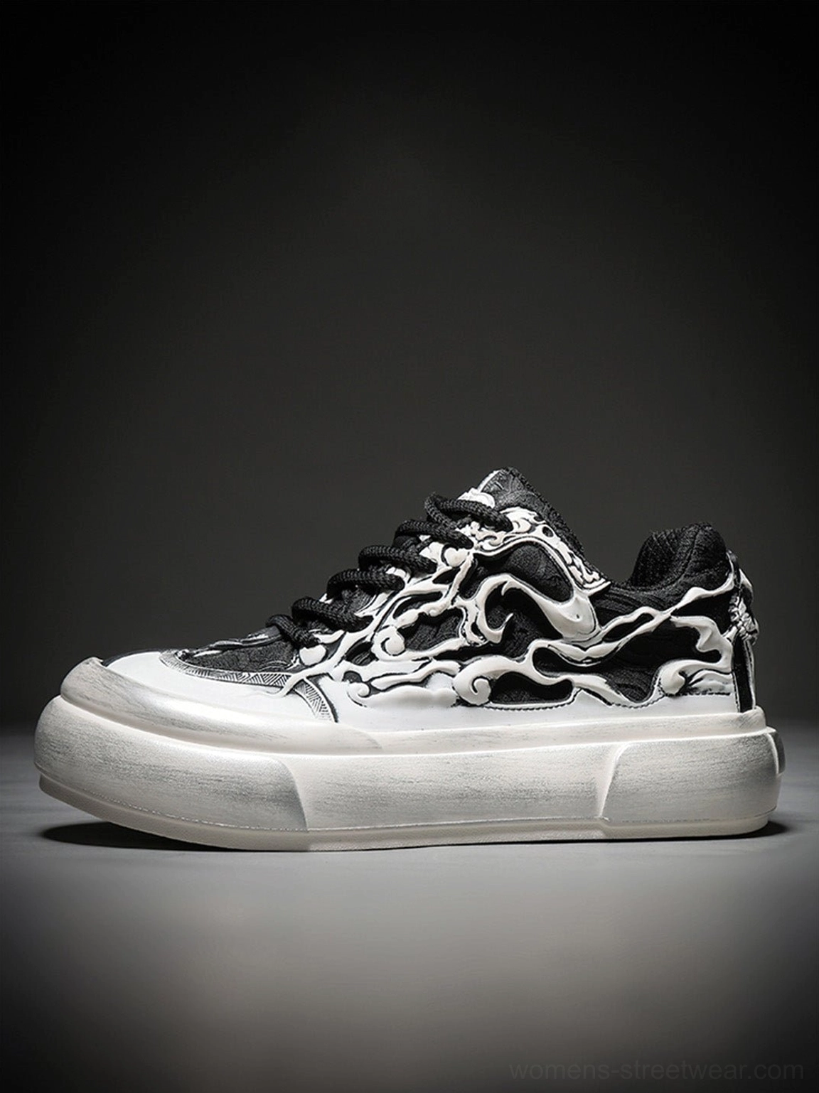 Side profile of a black and white flame print platform sneaker showing the full graphic upper thick white sole and lace-up design