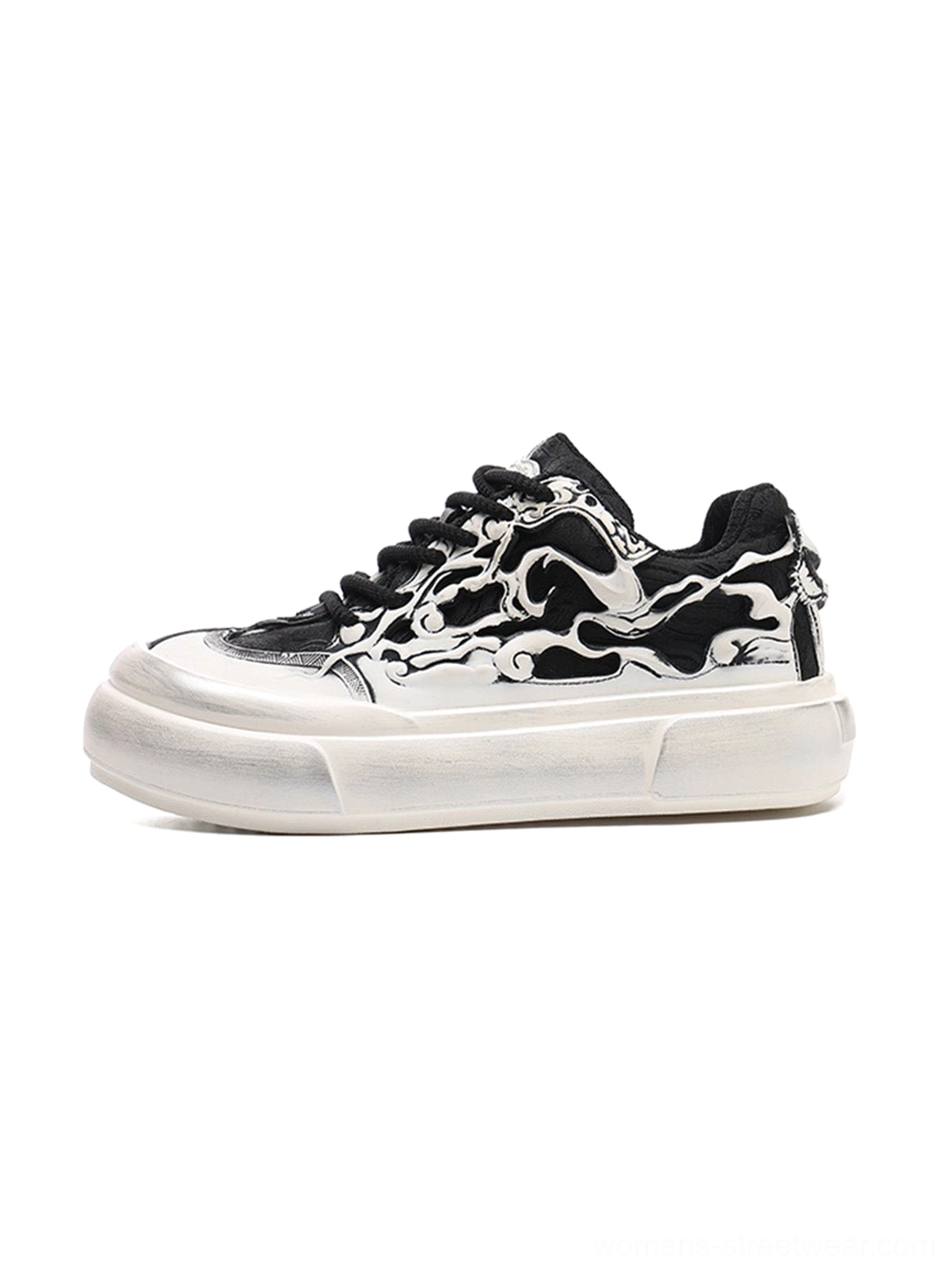 Black and white flame skull platform sneakers shown from a side three-quarter angle with chunky aged white sole and black laces