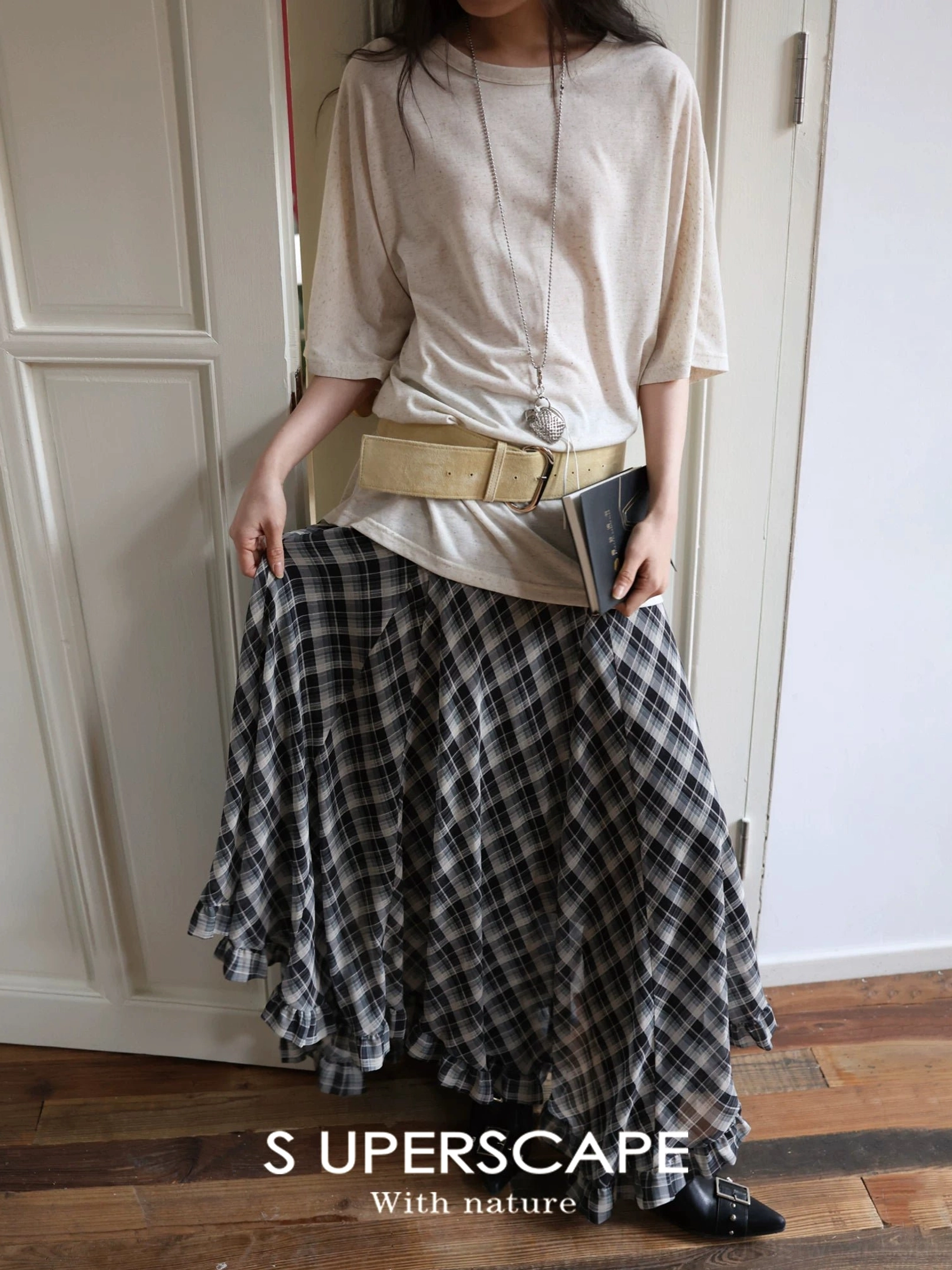 Black white and gray plaid chiffon asymmetric hem skirt styled with a beige loose tee and utility waist belt