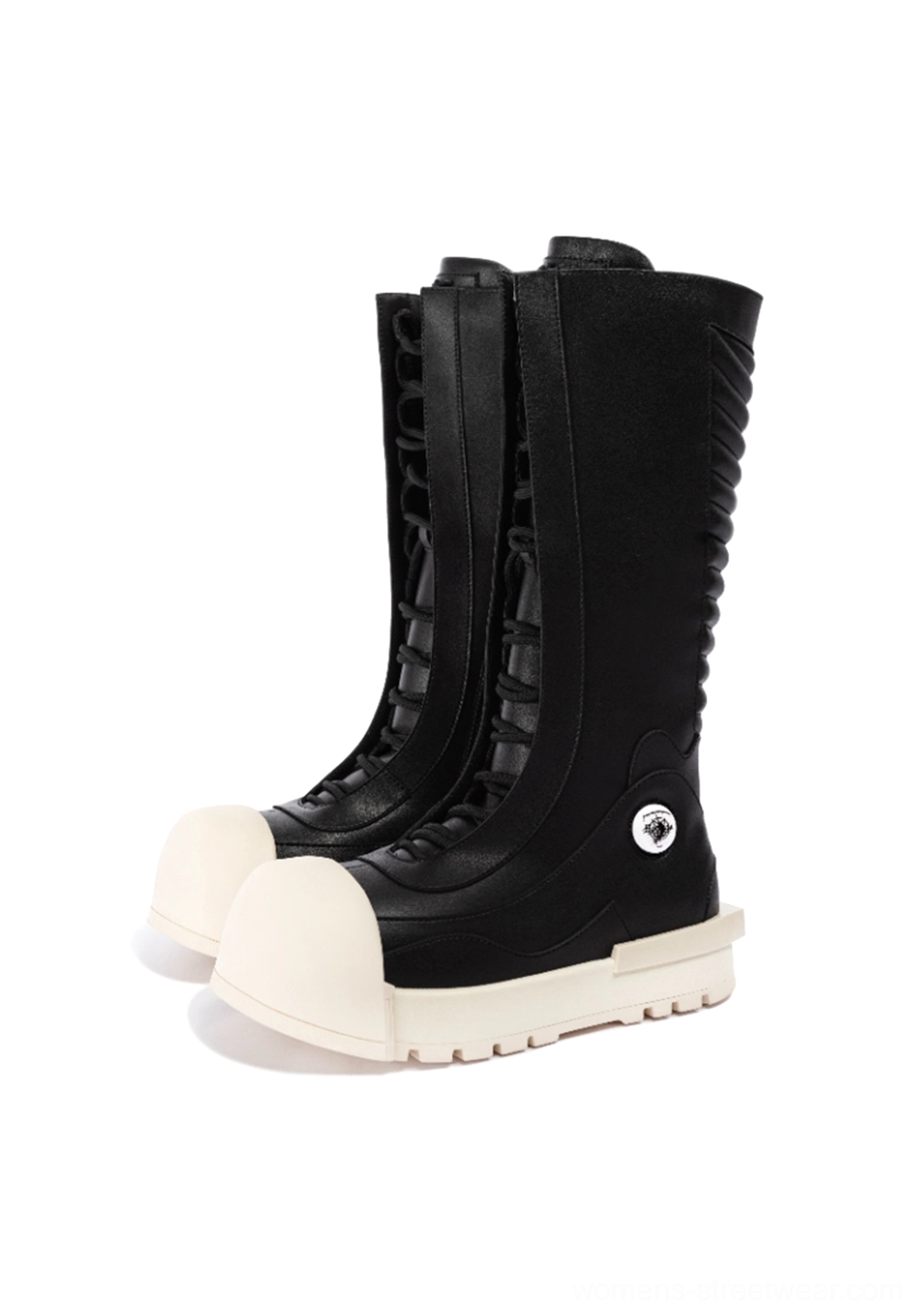 Front three-quarter view of black streetwear platform boots with rounded off-white toe caps, lace-up fronts, thick soles, and silver ankle details