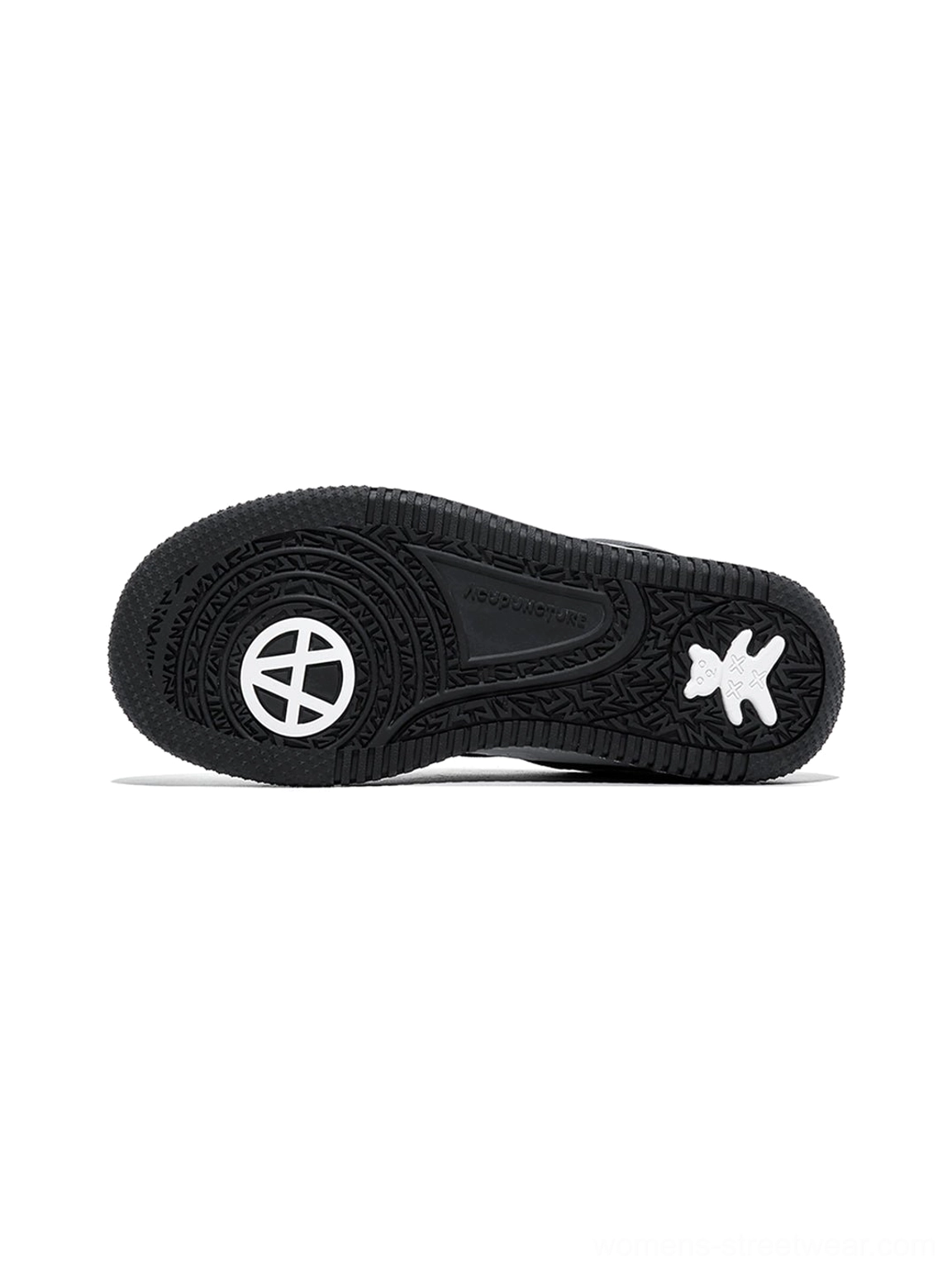 Black rubber outsole of a chunky black and white skate sneaker showing the patterned tread and graphic sole details