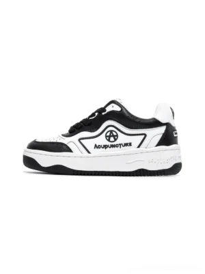 Black and white logo skate sneakers shown from the front on a clean white background with chunky rubber soles and contrast panel details