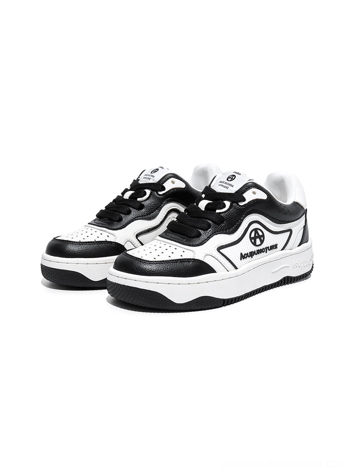 Pair of black and white graphic skate sneakers displayed together with retro board shoe styling and chunky rubber soles