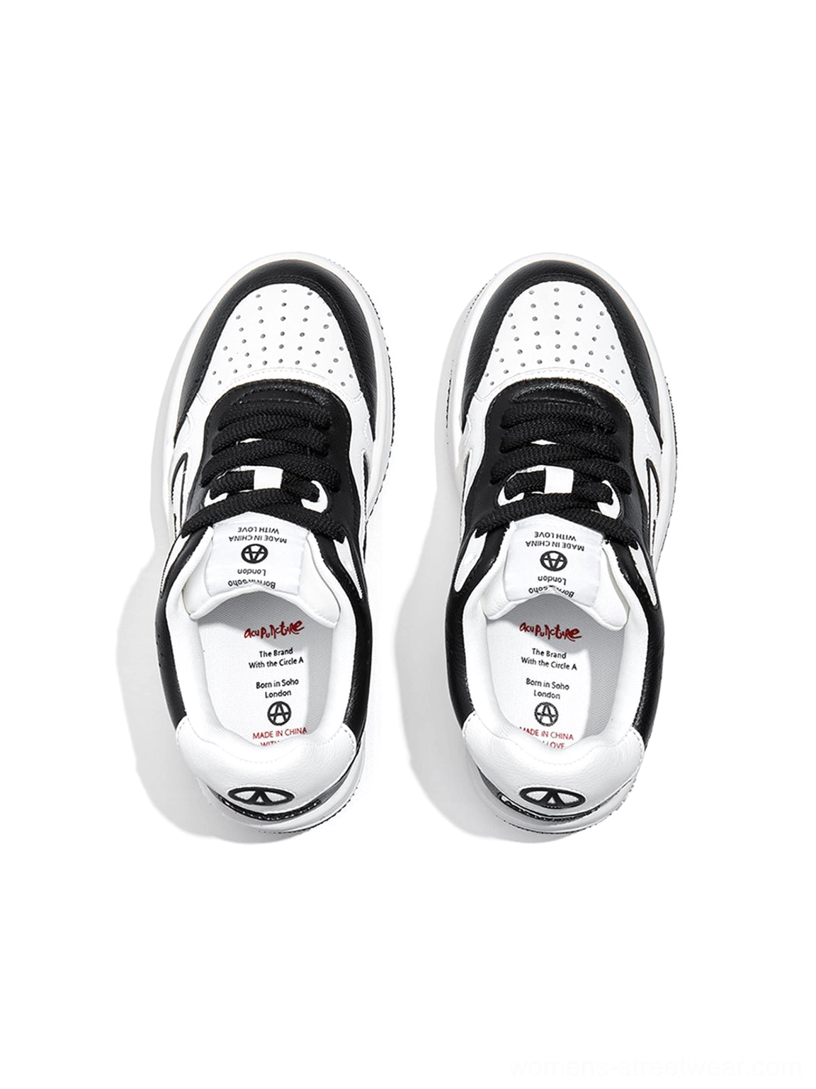 Top view of black and white logo skate sneakers showing the lacing system, perforated toe area, and contrast stitching