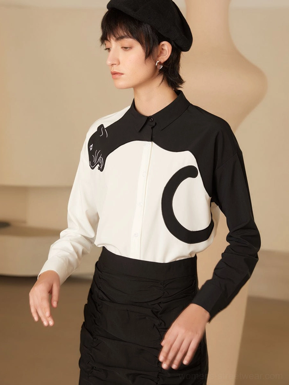 Natural three-quarter front view of black and white panther blouse with tailored collar and smooth woven fabric