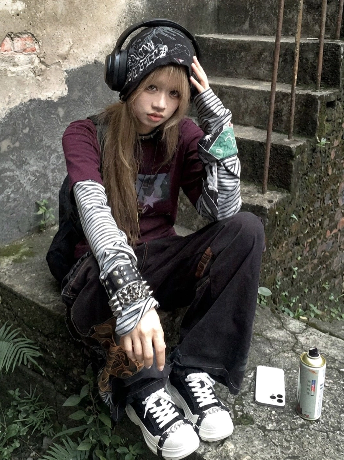 Female Y2K street style outfit featuring black and white buckle platform canvas sneakers on outdoor industrial stairs