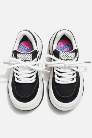 Pair of black and white platform chunky sneakers shown from a top-down view with round toes, lace-up design, graphic insoles, and Y2K streetwear styling