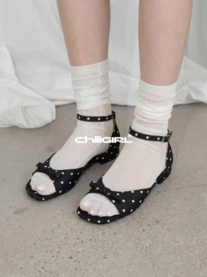Black and white polka dot open toe ankle strap sandals styled with white crew socks