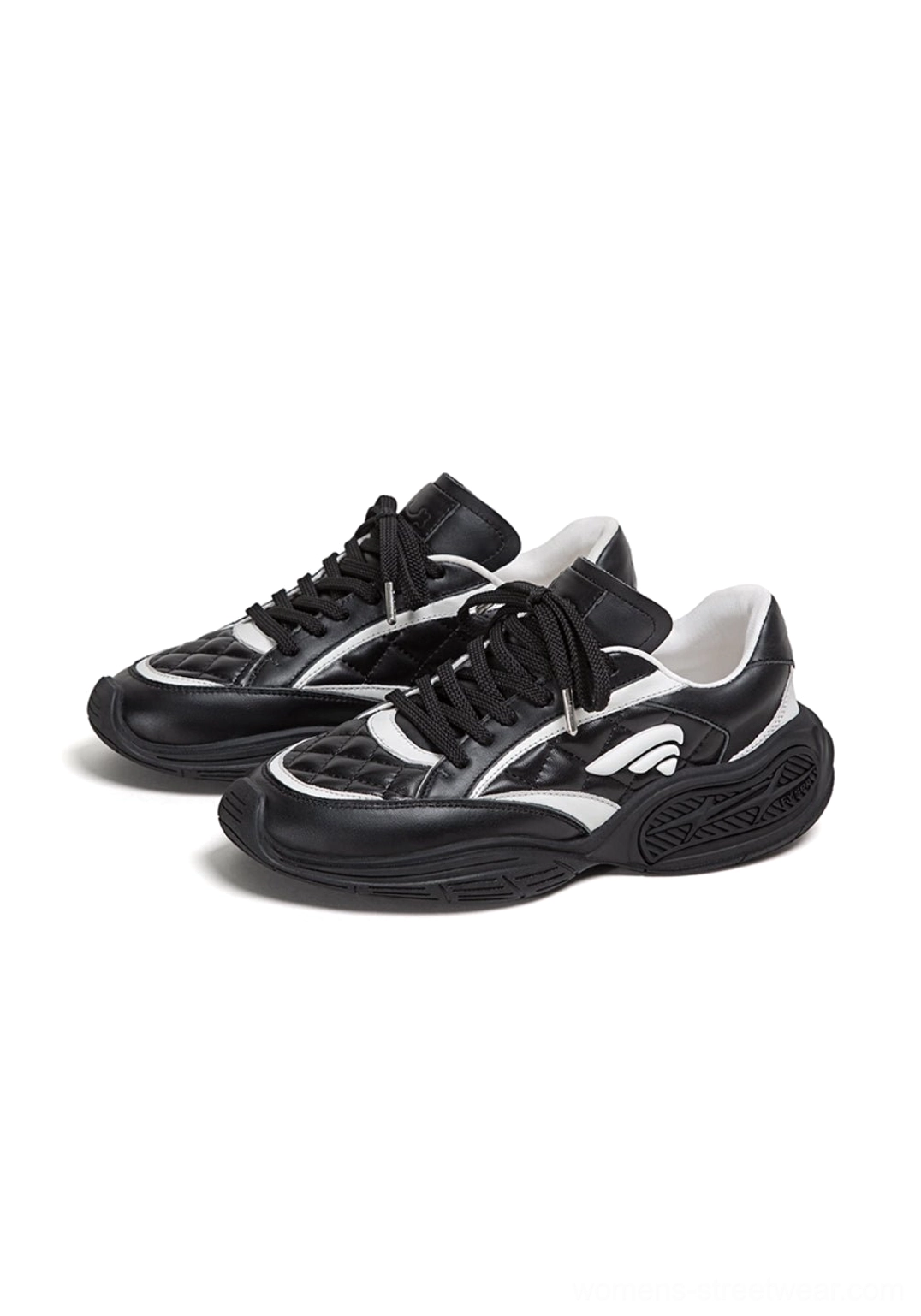 Pair of black and white quilted leather sport sneakers shown from an angled overhead view with lace-up fronts