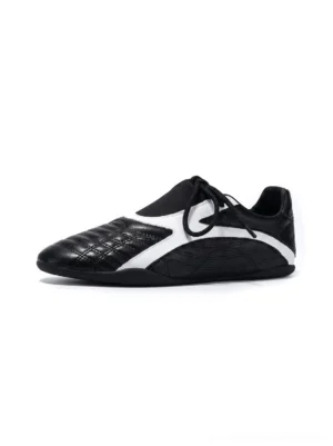 Black and white quilted toe low-profile streetwear sneakers with contrast side panels shown from a front side angle on a white background