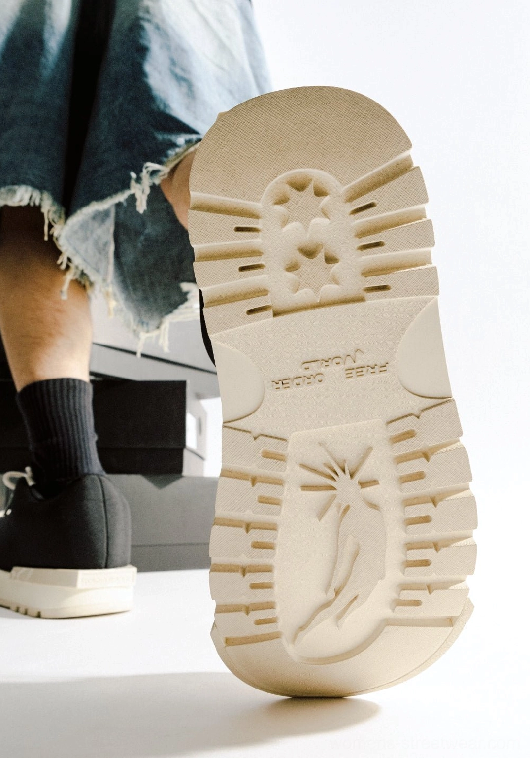 Off-white lug outsole detail of black and white sculpted toe chunky platform low boots with textured traction pattern
