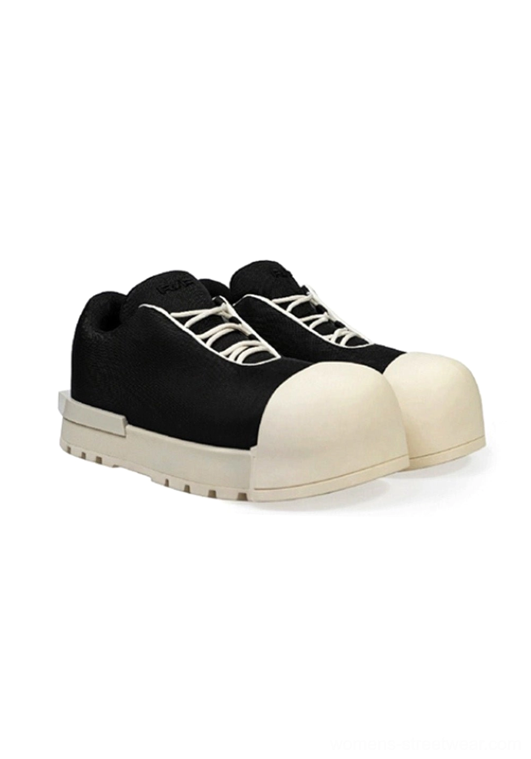 Pair of black and white sculpted toe chunky platform low boots front studio display with contrast toe caps