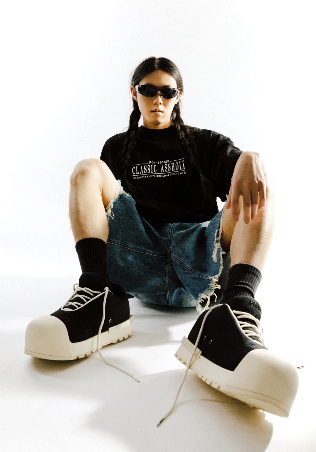 Front low angle view of black and white sculpted toe chunky platform low boots worn with graphic streetwear outfit