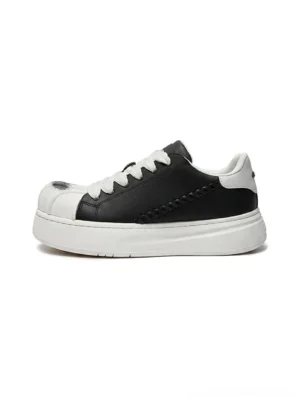 Black and white shell toe platform derby sneaker shown in left profile with black synthetic leather upper, white sculpted toe cap, chunky platform sole, and woven heel stitching