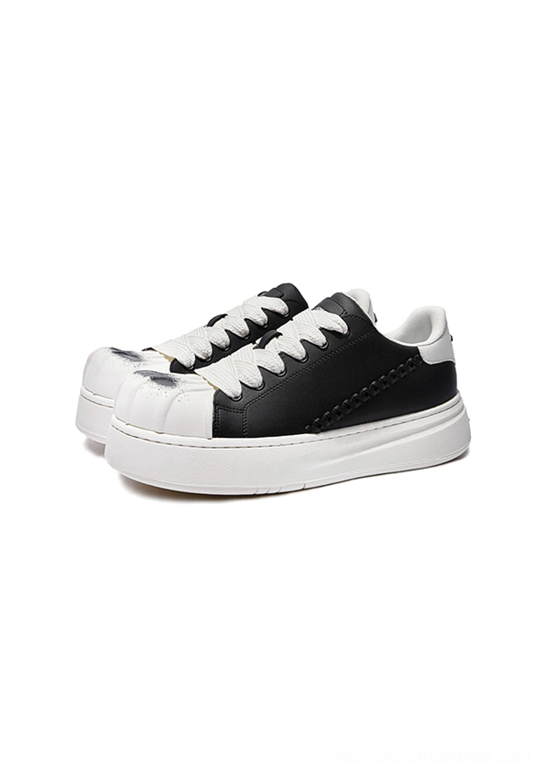 Black and white shell toe platform derby sneakers highlighting the unisex streetwear design, substantial sole, and bold black-and-white color blocking