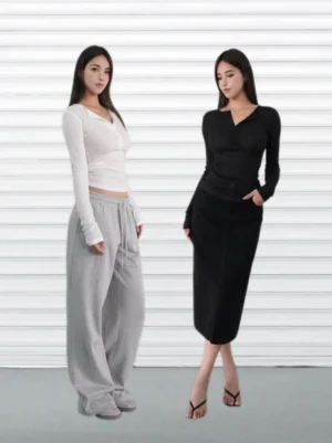 Black and white slim-fit ribbed Henley long sleeve tops shown side by side with grey sweatpants and a black split midi skirt