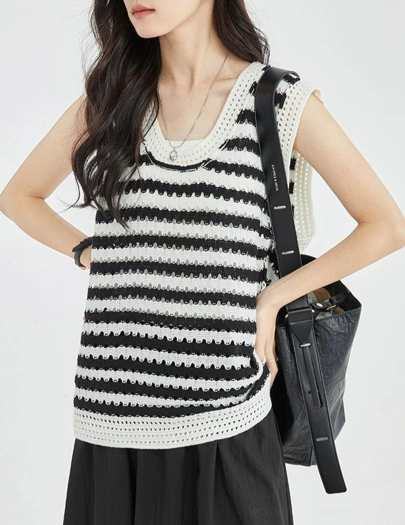 Detailed side front view of a black and white striped crochet knit sleeveless top showing the textured weave, rounded U neckline, and delicate contrasting edge