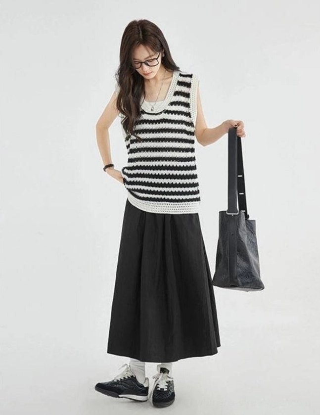 Full side view of a black and white striped crochet knit vest top showing its relaxed daily casual silhouette, sleeveless design, and all-over stripe pattern