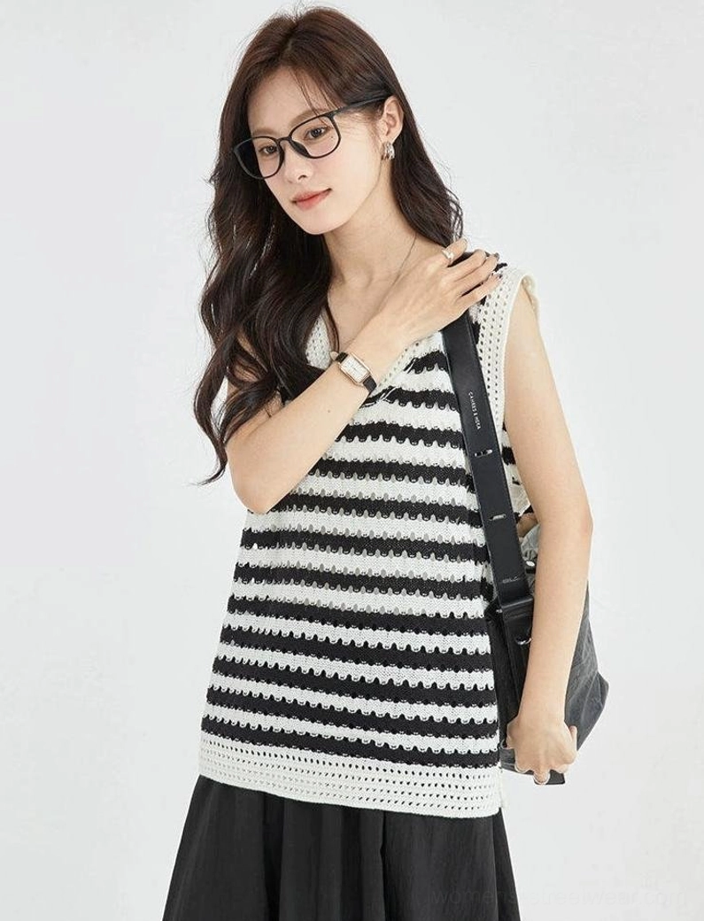 Close front view of a black and white striped crochet sleeveless knit top featuring a wide relaxed cut, textured weave, and contrasting neckline trim