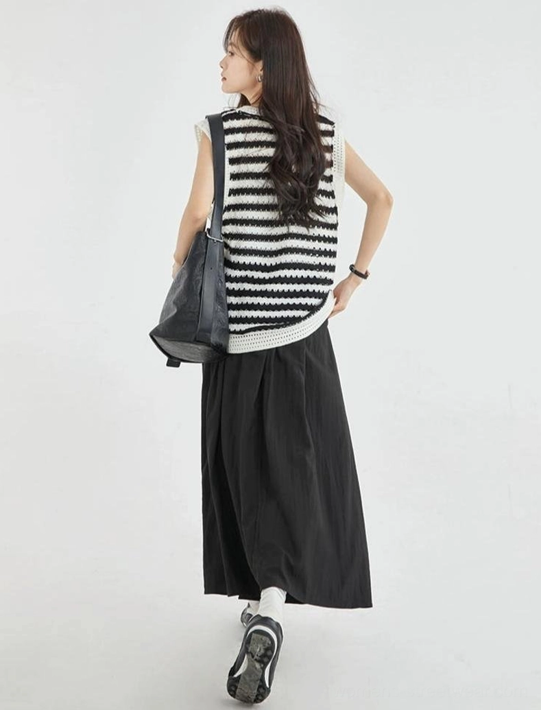 Back view of a black and white striped crochet sleeveless knit vest top showing the relaxed fit, all-over stripe pattern, and matching crochet trim