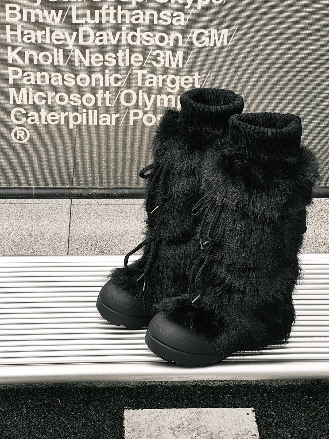 Close view of black and white tall platform boots with plush seasonal lining detail