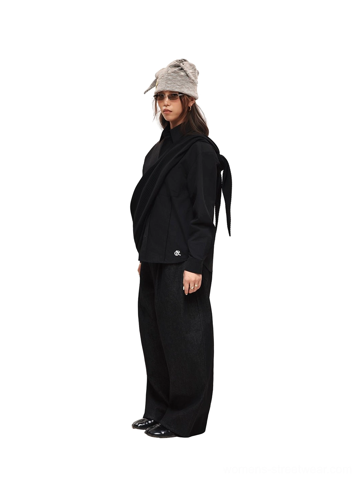 Front styling view of black wide-leg denim pants with a neat waist fit, bucket hat, sunglasses, and modern streetwear accessories