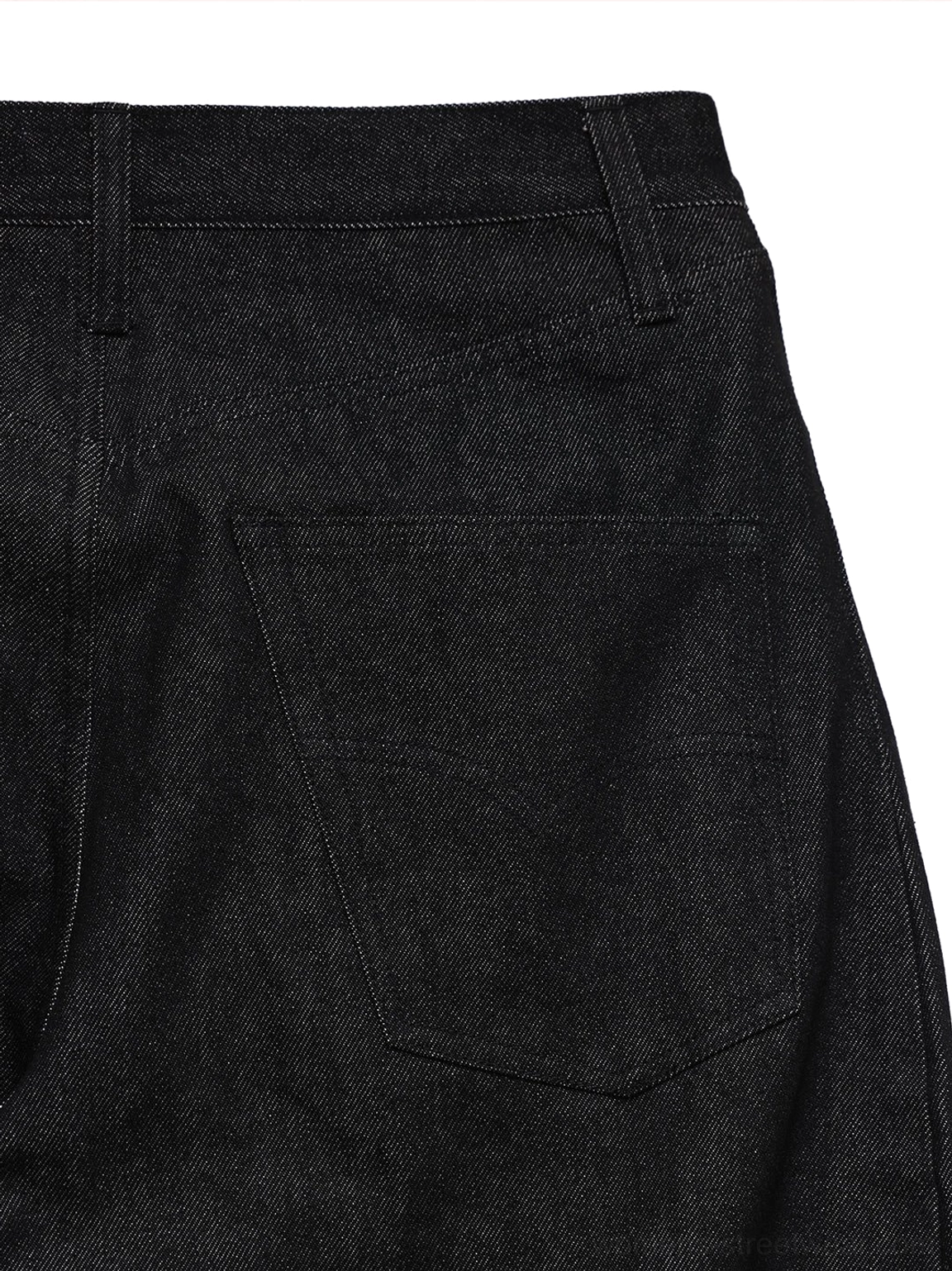 Partial rear close-up of black wide-leg denim pants showing visible stitching, single rear patch pocket, belt loops, and crisp seams