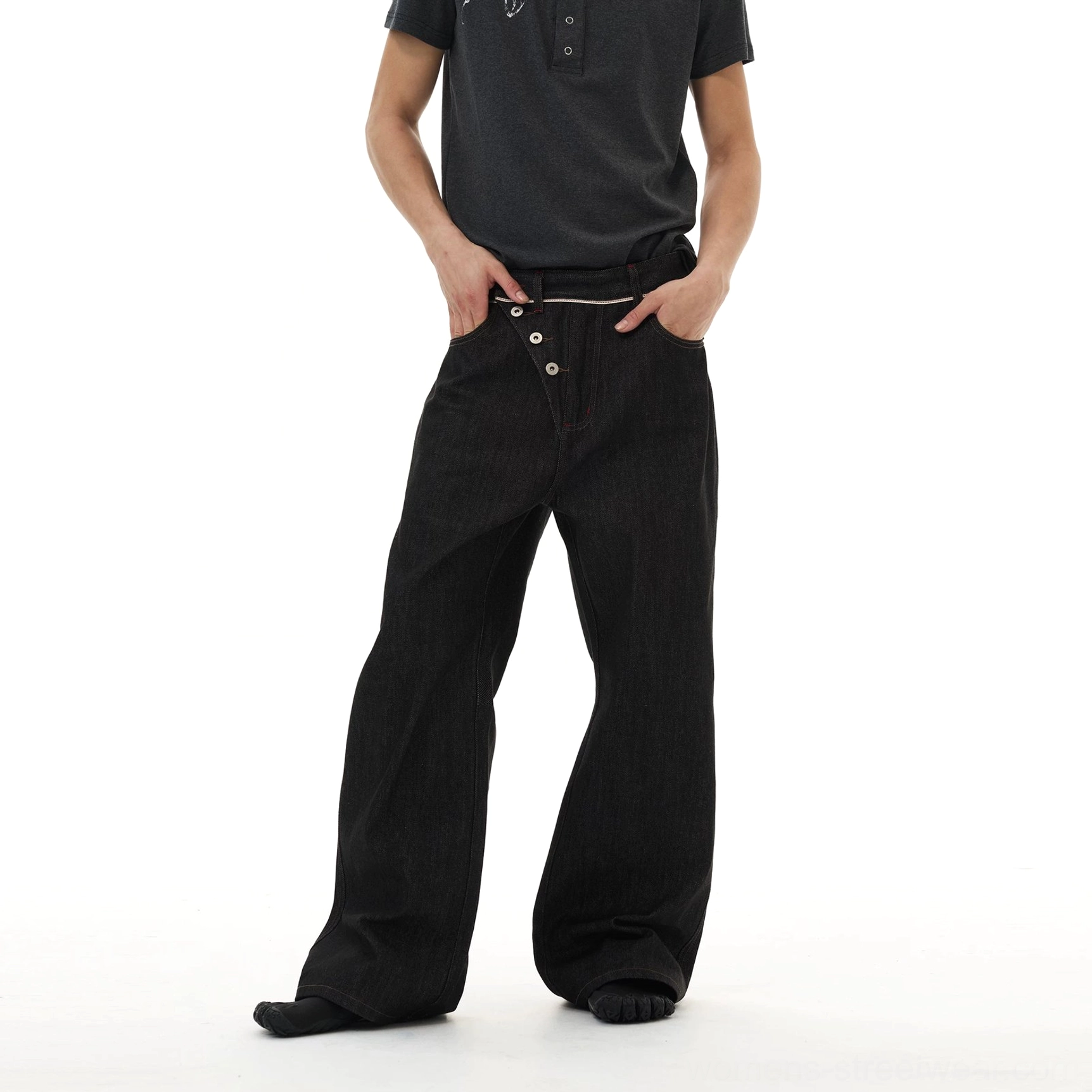 Black wide-leg streetwear denim jeans with deconstructed asymmetric front closure and oversized relaxed silhouette