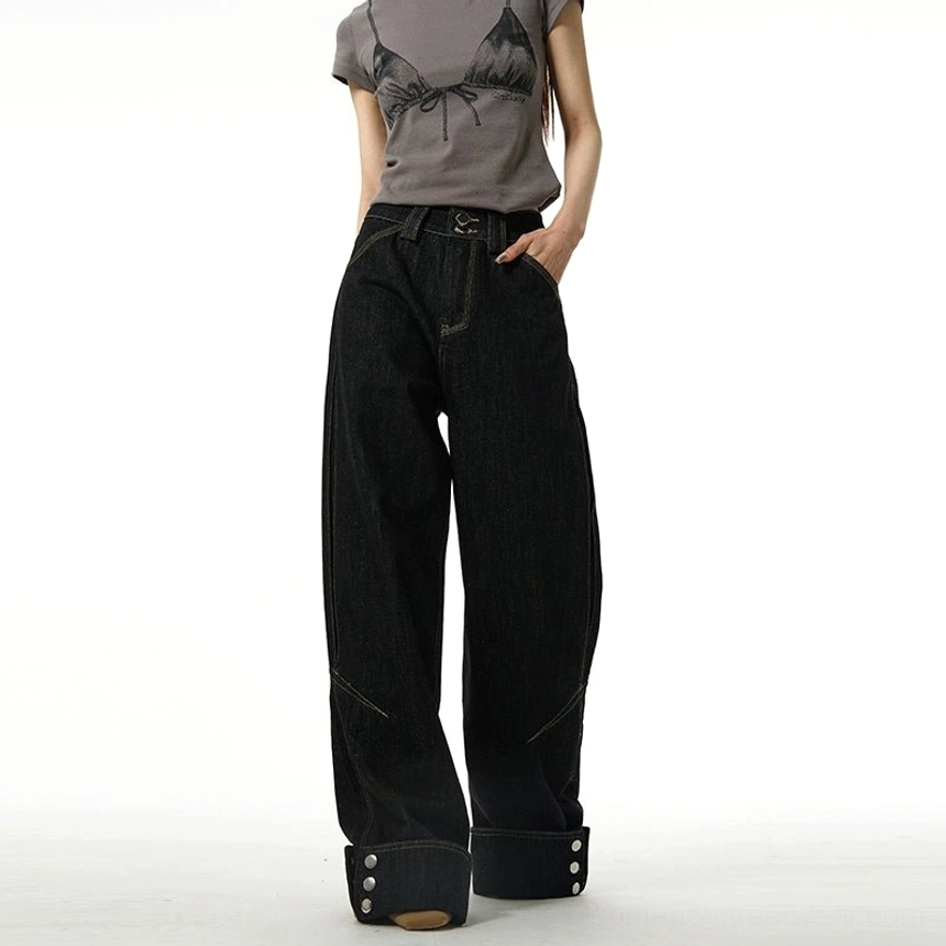 Black wide-leg streetwear jeans featuring rolled button cuffs, dark cotton denim, and versatile urban styling