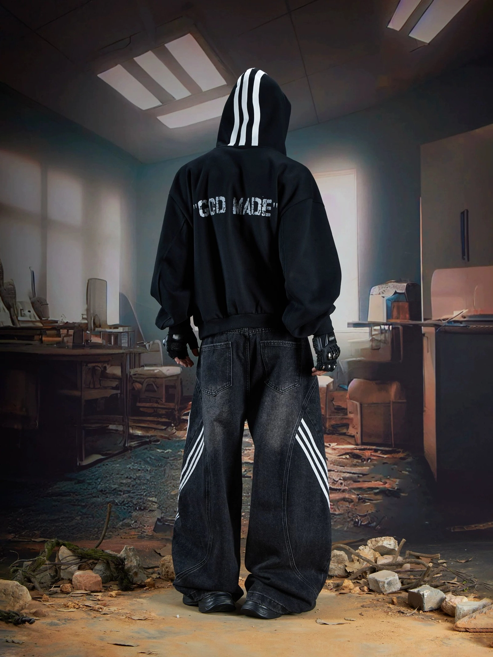 Full-body back view of black wide-leg stripe jeans styled with a graphic hoodie, showing the rear stripe detail and oversized Seoul streetwear silhouette