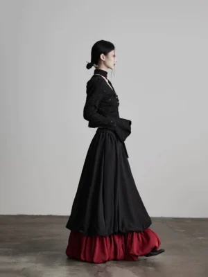 Side view of black and wine red faux two-piece A-line maxi skirt styled in gothic streetwear fashion