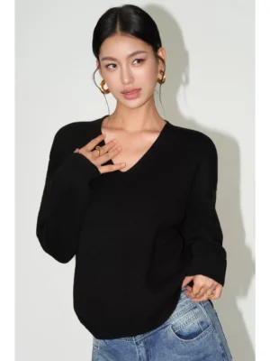 Black women's Korean streetwear V-neck knit sweater with a relaxed fit styled with blue denim jeans