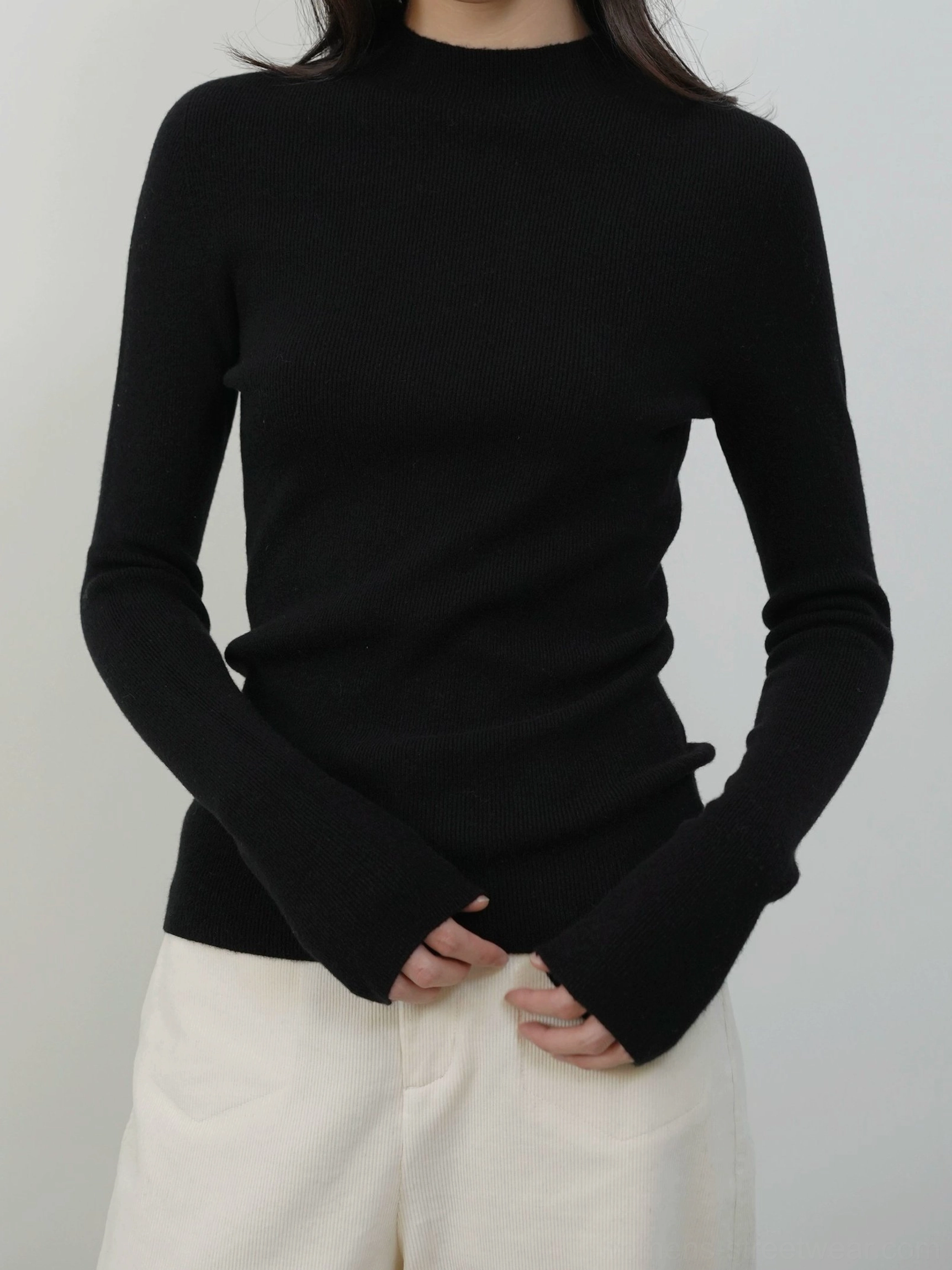 Black women's mock neck knit sweater with vertical ribbing for sleek Acubi style and modern streetwear outfits